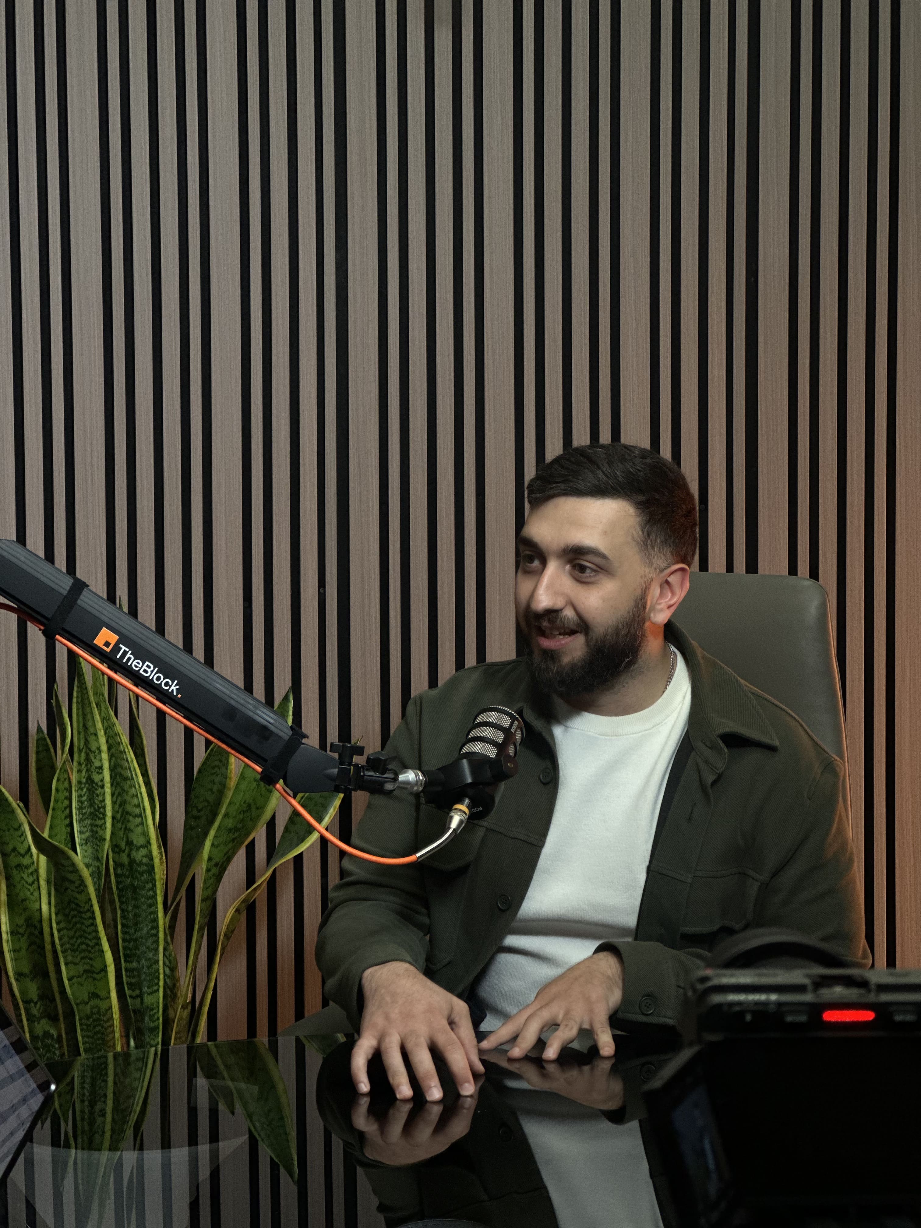 Arman Mamyan speaking on stage at a conference
